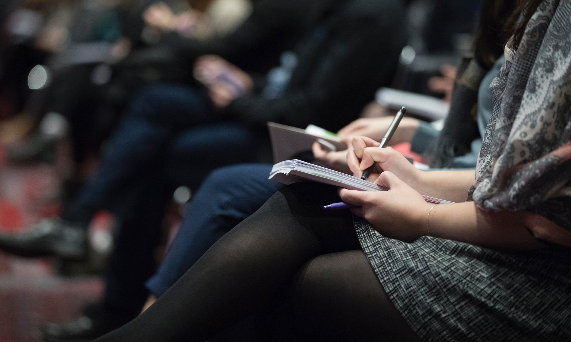 Person taking notes at a conference